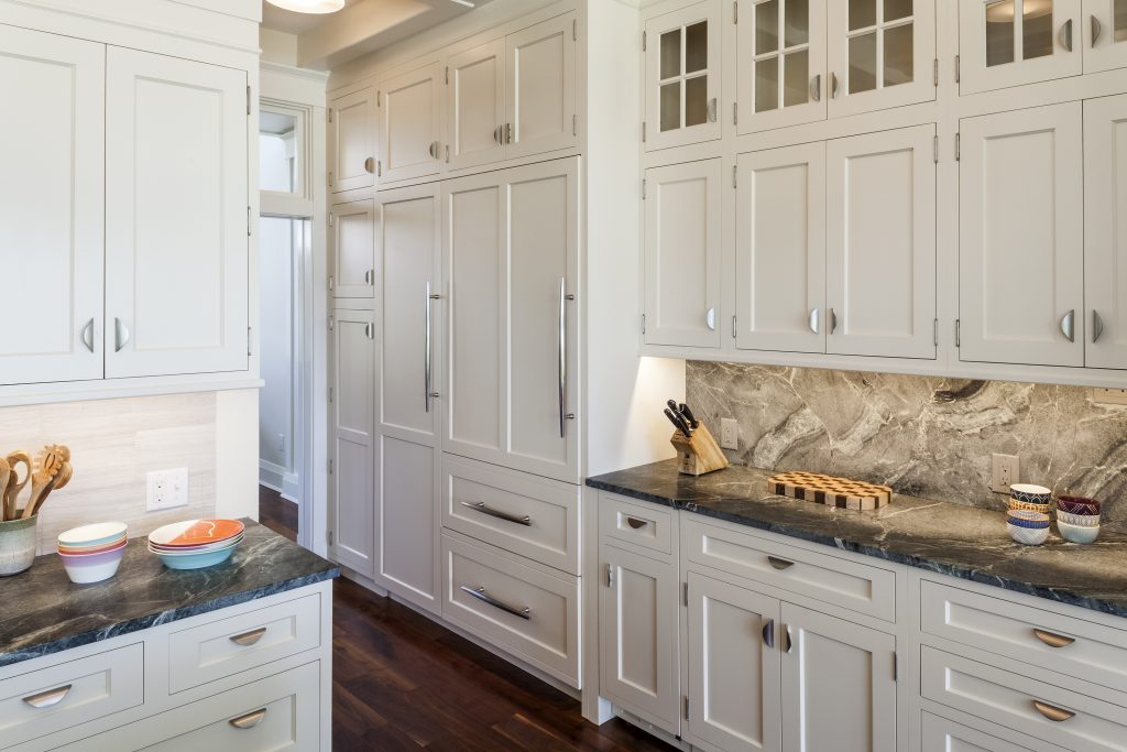 This kitchen was designed to conveniently and brilliantly hide all the dishes, pots, pans, cutlery and appliances behind a polished and organized wall of gloriously crafted custom cabinetry.  
